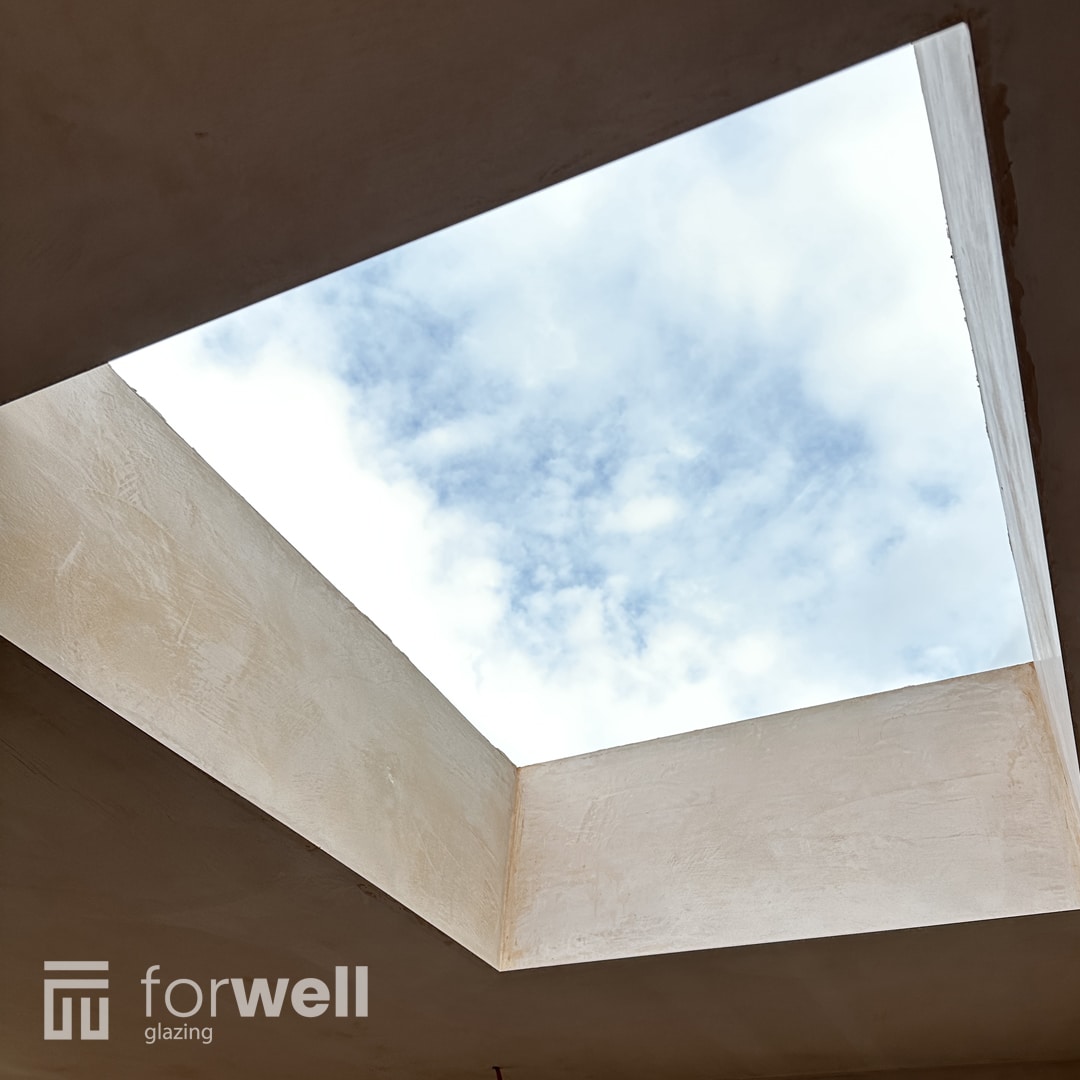 Flat roof skylight seen from inside, filling the room with light Flat roof skylight seen from inside, filling the room with light