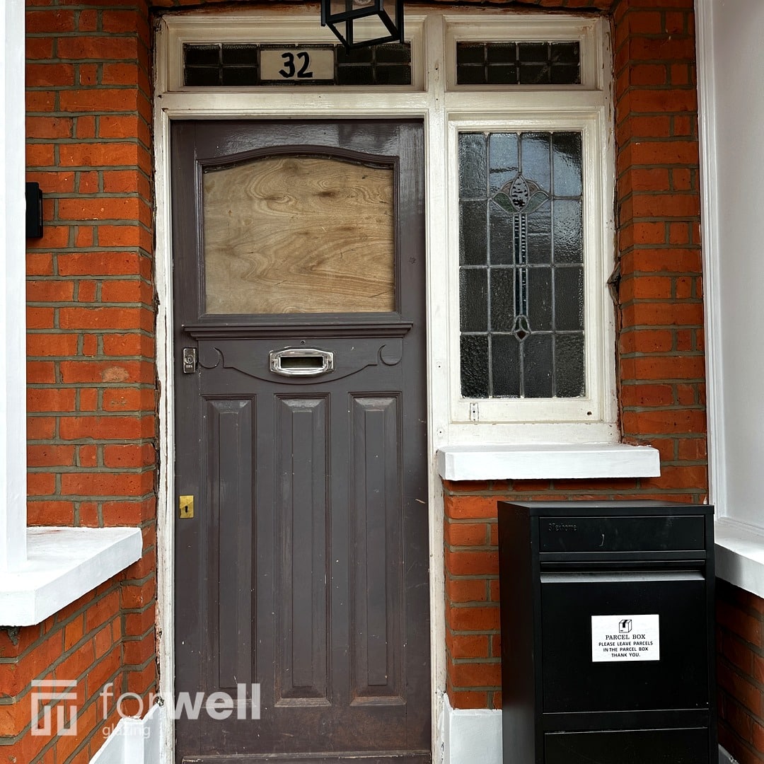 Grey front door with a glazed top light Grey front door with a glazed top light