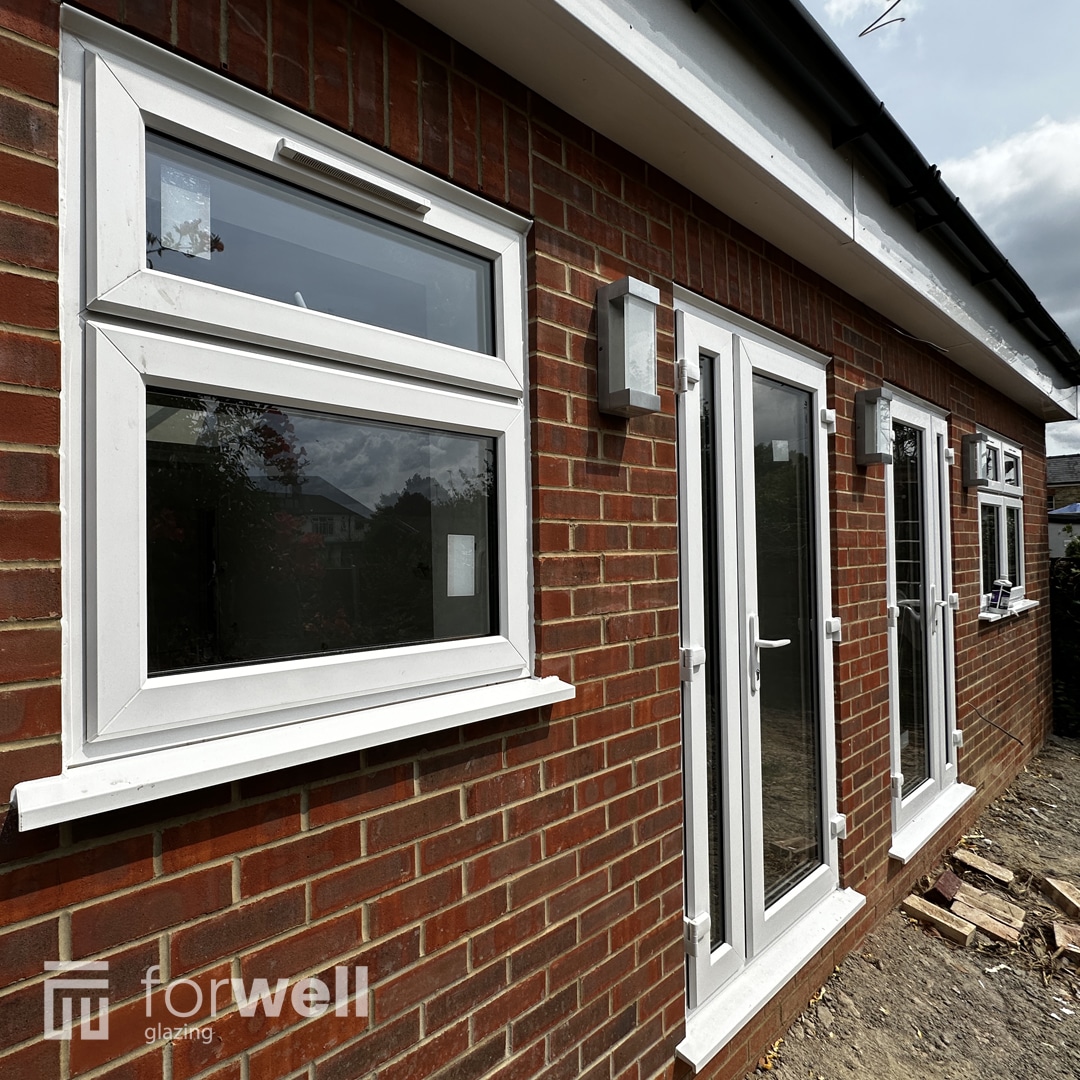 New white uPVC windows and French doors on a rear extension New white uPVC windows and French doors on a rear extension