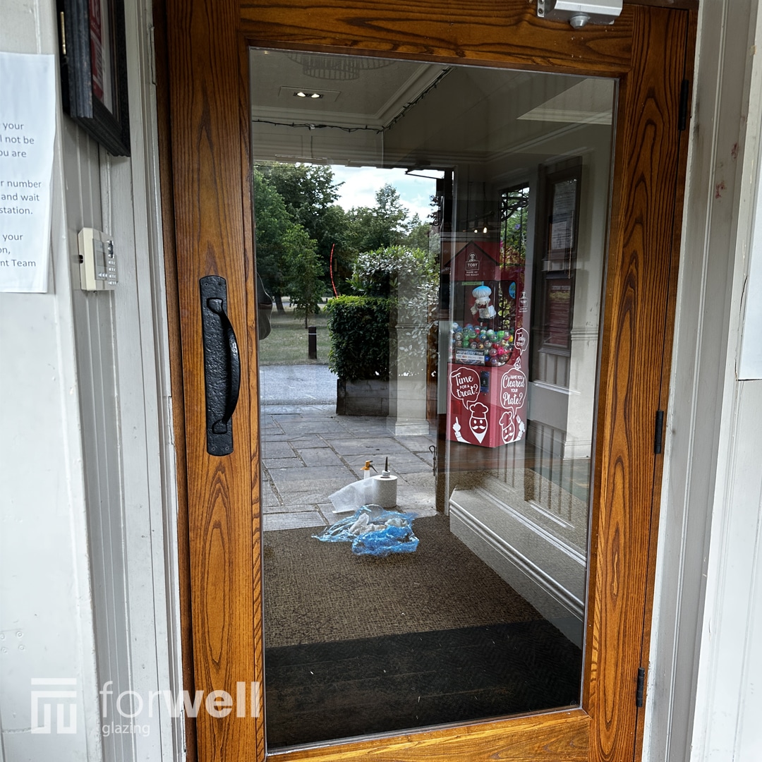 New woodgrain door installed with a glazed panel New woodgrain door installed with a glazed panel